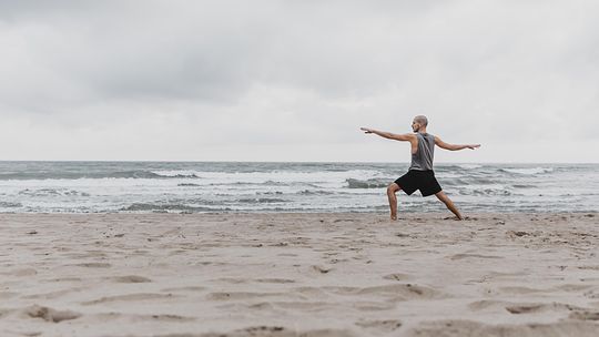 side-view-man-beach-exercising-yoga-with-copy-space.jpg